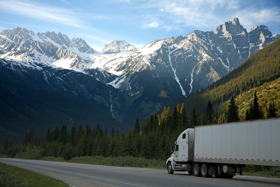 Truck in front of mountain scene