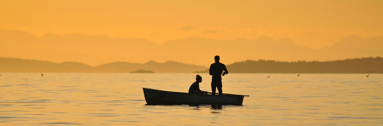 fishing on a lake during sunset