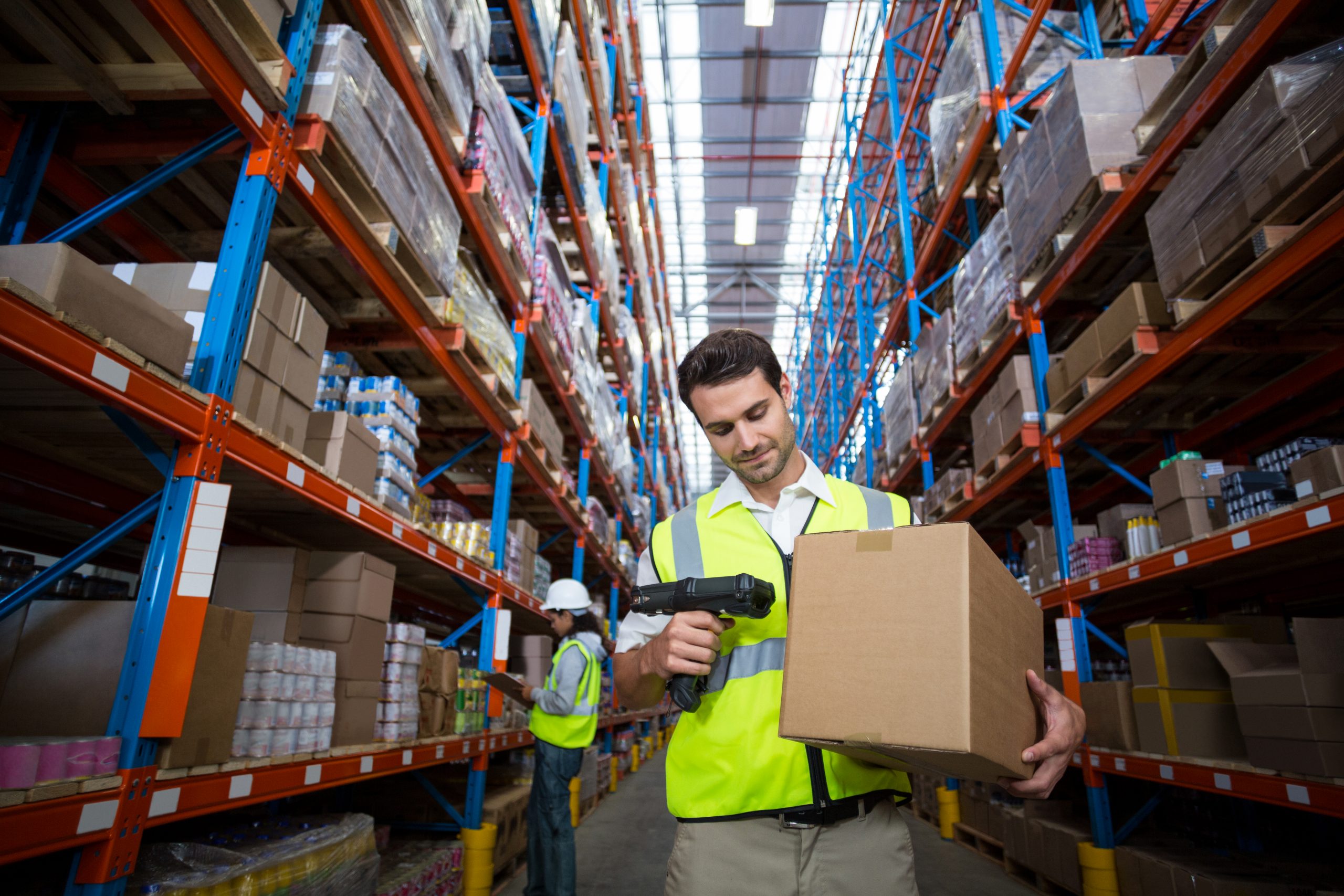 Warehouse worker using scanner in warehouse