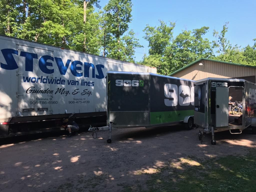Guindon Moving truck next to the 906 Adventure Team trailers ready to transport competitor's bikes