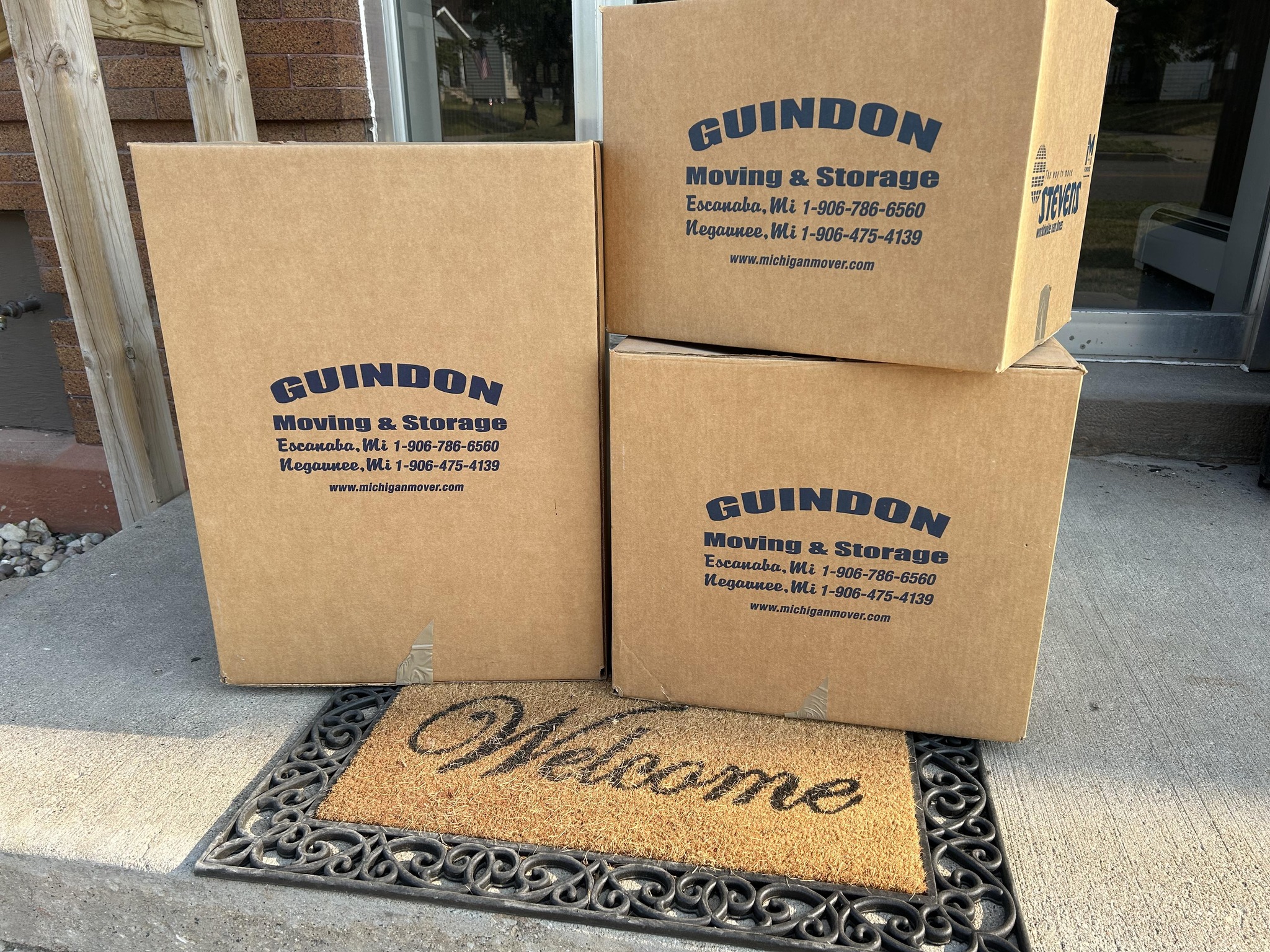 three boxes by a welcome mat