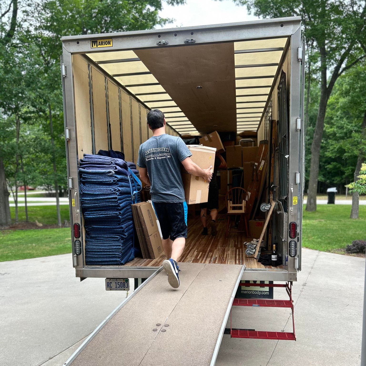 Guindon crew member loading boxes onto the moving truck